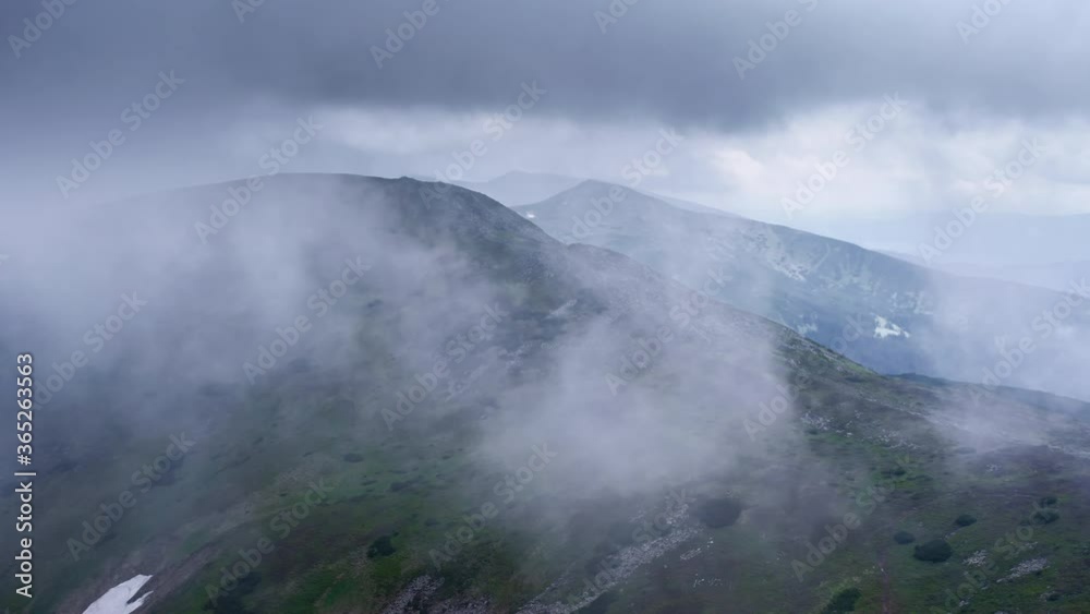 Flying through the clouds above mountain tops. High peaks wonderful dramatic clouds natural Landscape Flying through the clouds above mountain tops. High peaks wonderful dramatic clouds natural Landscape