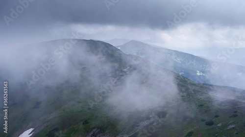 Wallpaper Mural Flying through the clouds above mountain tops. High peaks wonderful dramatic clouds natural Landscape Torontodigital.ca