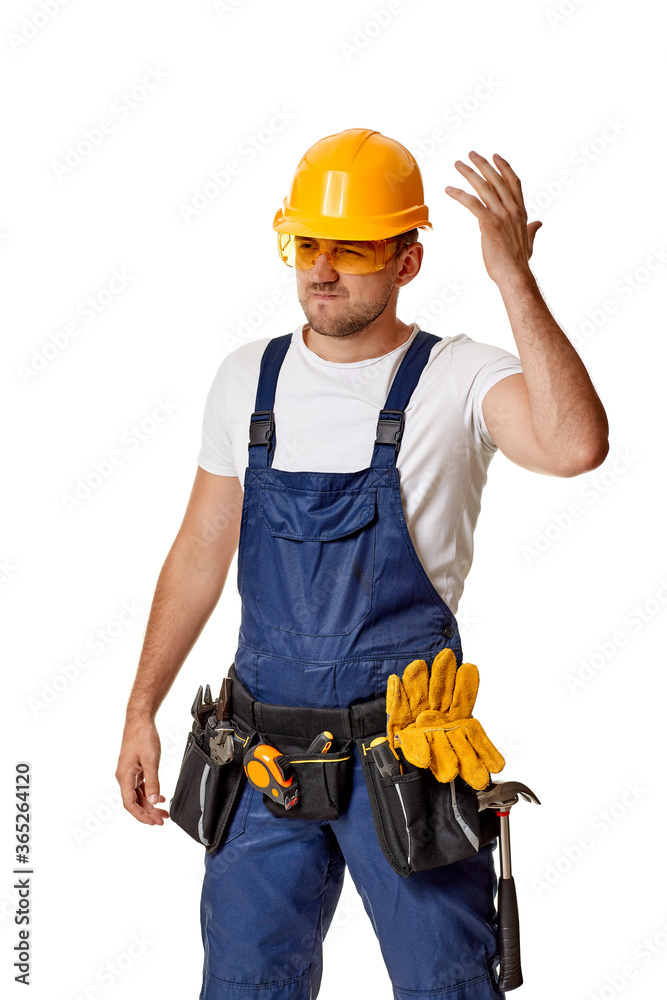angry caucasian repairman worker in yellow hard hat and uniform. handyman wearing tool belt isolated on white studio background angry caucasian repairman worker in yellow hard hat and uniform. handyman wearing tool belt isolated on white studio background