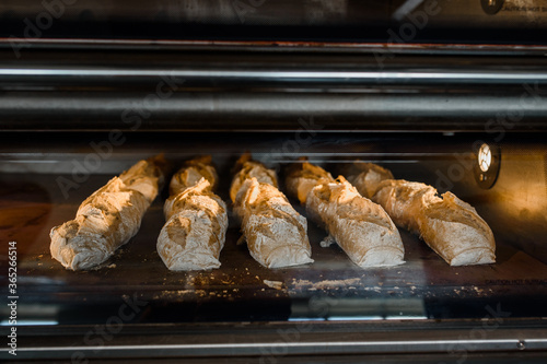 Close up bread baguette baking process in a bakery manufacturing.