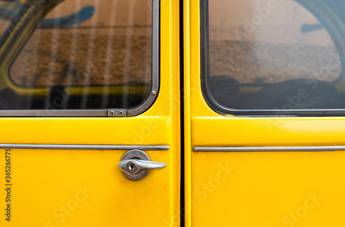 Schilderij op canvas Close-up detail of a Black Yellow vintage citroen 2cv car