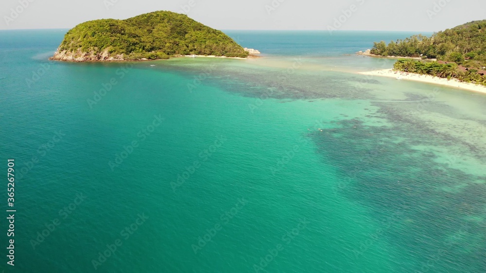 Aerial drone view small Koh Ma island, Ko Phangan Thailand. Exotic coast panoramic landscape, Mae Haad beach, summer day. Sandy path between corals. Vivid seascape, mountain coconut palms from above.
