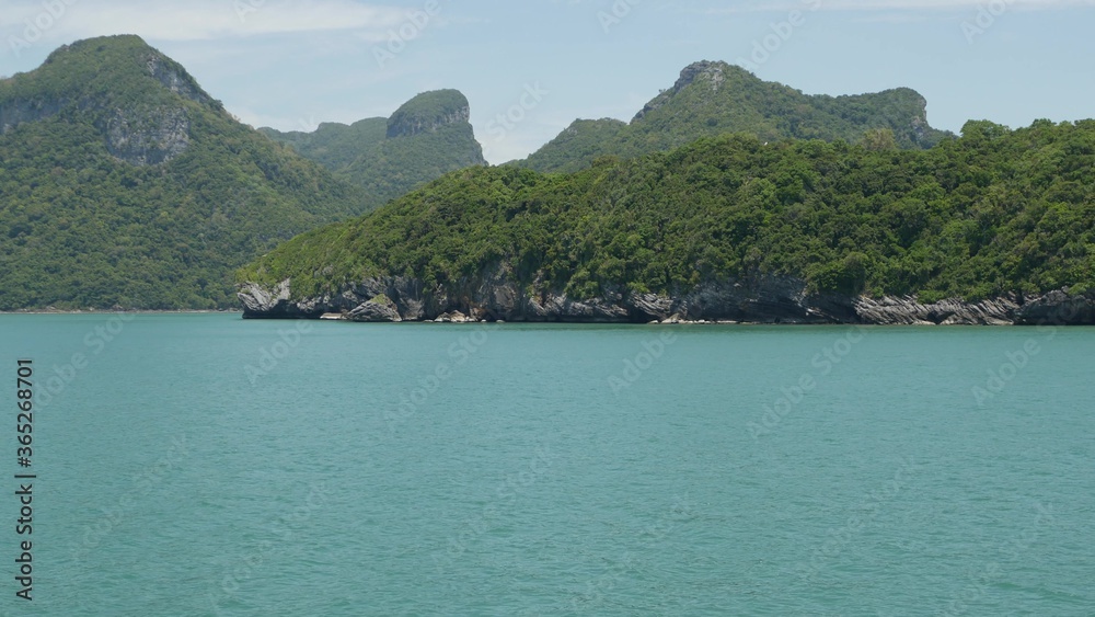Group of Islands in ocean at Ang Thong National Marine Park near touristic Samui paradise tropical resort. Archipelago in the Gulf of Thailand. Idyllic turquoise sea natural background with copy space