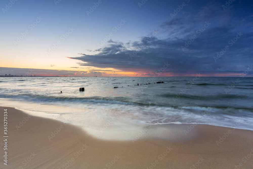 Beautiful sunset over the beach by the Baltic Sea in Gdansk, Poland.