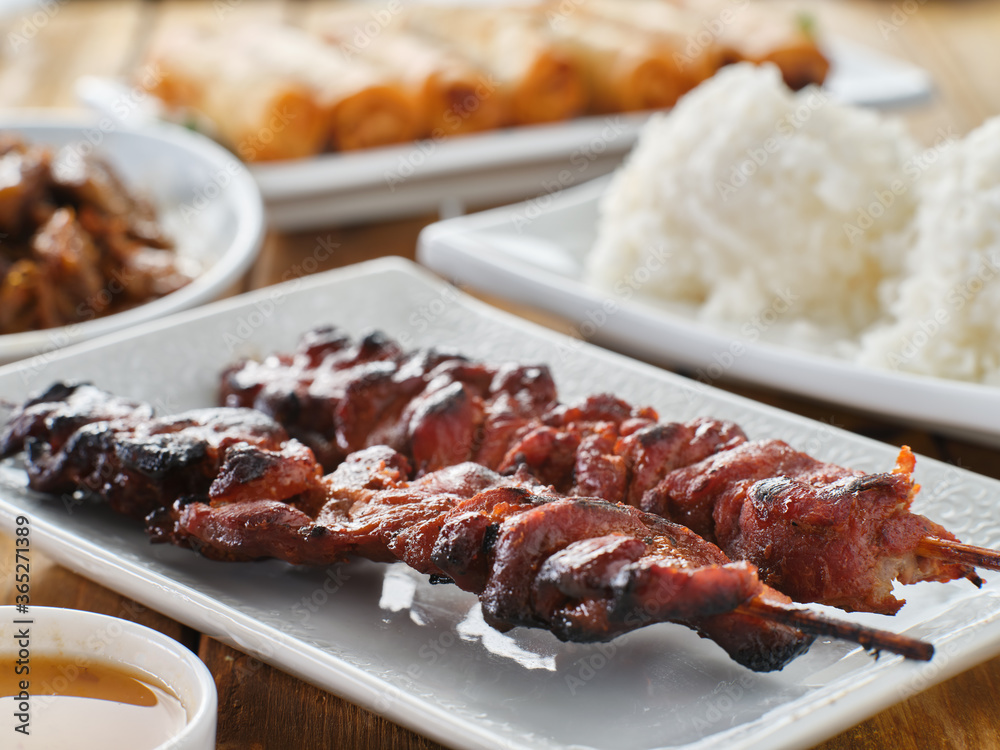 plate of two filipino style pork bbq skewers on plate