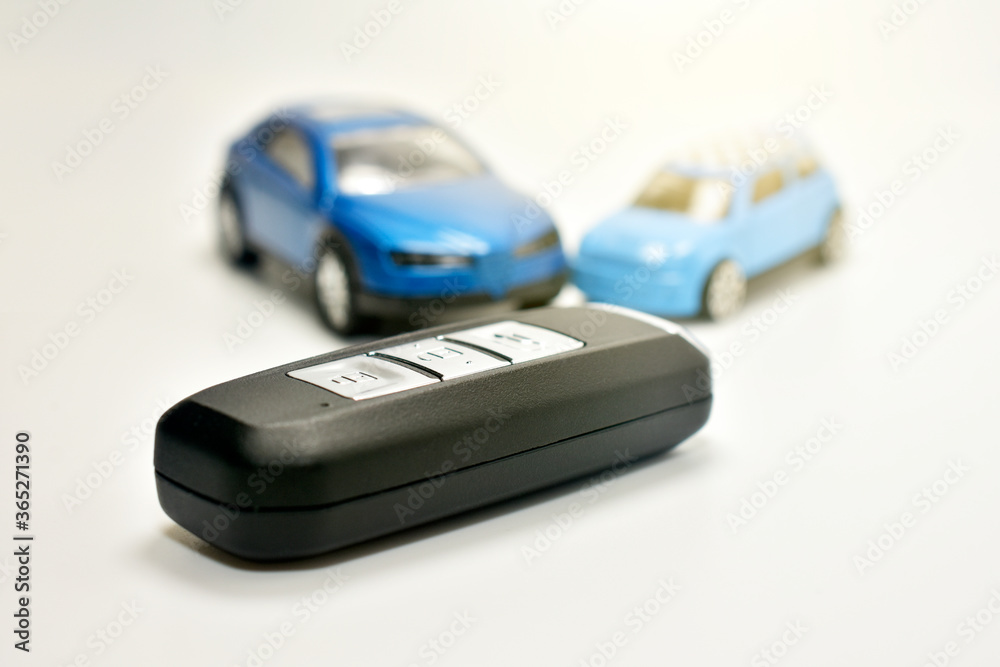 Key car on white table and car model background Key car on white table and car model background