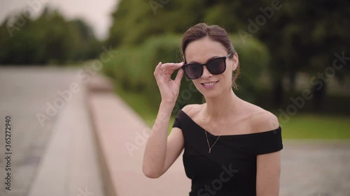 Businesswoman is wearing sunglasses in the park