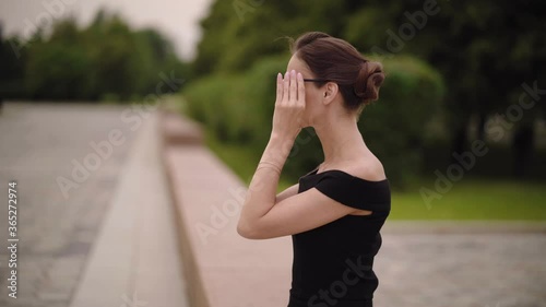Fashionable beautiful woman is wearing sunglasses in the summer park