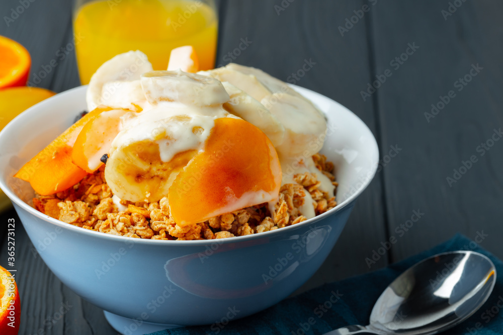 Bowl of granola with youghurt and sliced fruits Bowl of granola with youghurt and sliced fruits