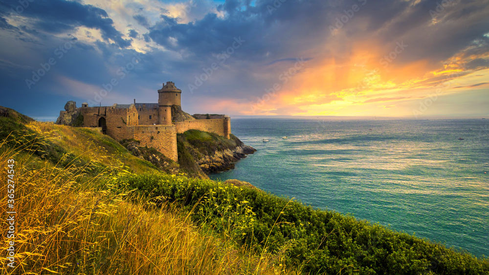 Fort La Latte, Brittany, France, at sunset. 14th century fortress built on a cliff in the Baie de la Fresnaye, a bay on the English Channel of the Côte d'Émeraude.