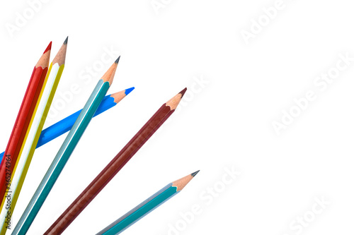 Six different colored wood pencil crayon scattered on a white background