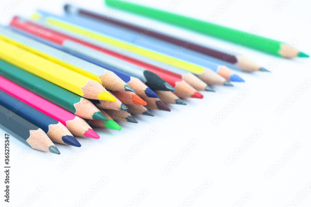 Lot of different colored wood pencil crayon scattered on a white background Lot of different colored wood pencil crayon scattered on a white background