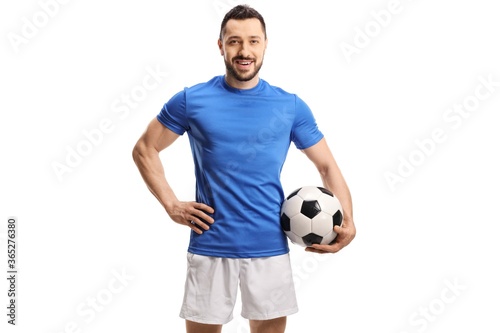 Soccer player in a blue jersey holding a football