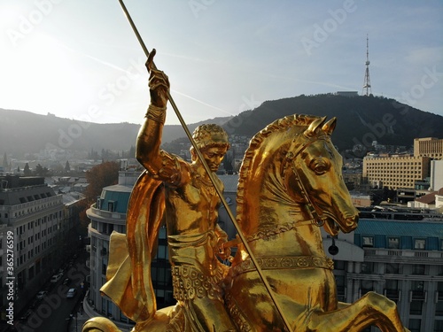 Beautiful aerial drone photography. Country Georgia from above. Capital Tbilisi. Liberty square and close up portrait of  saint George golden monument.