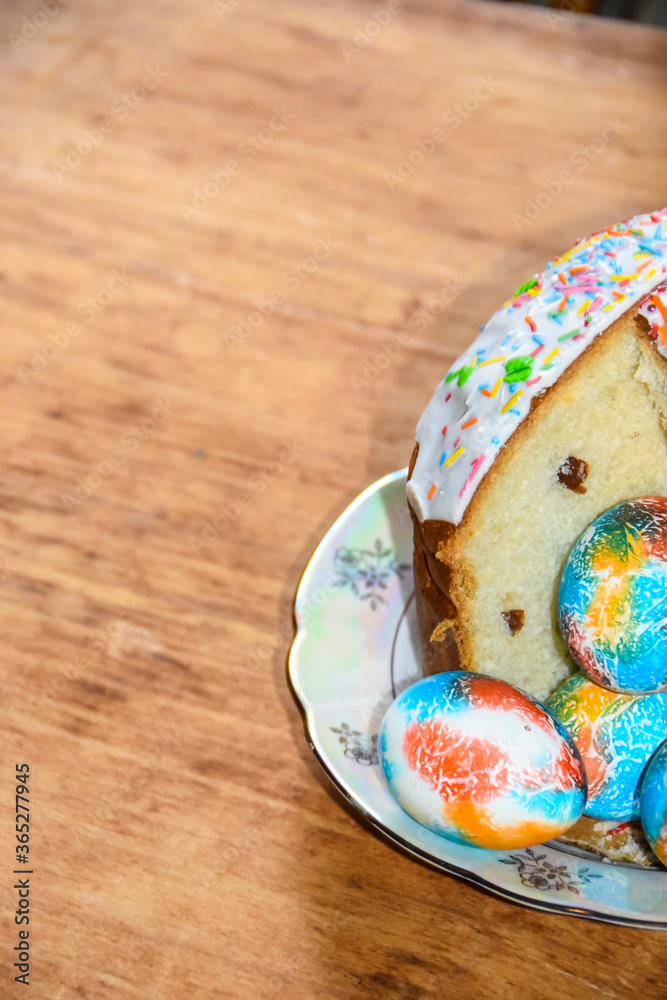 rich Easter cake and multi-colored painted eggs on a plate