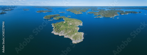 Fototapeta Naklejka Na Ścianę i Meble -  Aerial panoramic view of beautiful islands with forest in Baltic sea. Blue sky. Saaristomeri. Finland