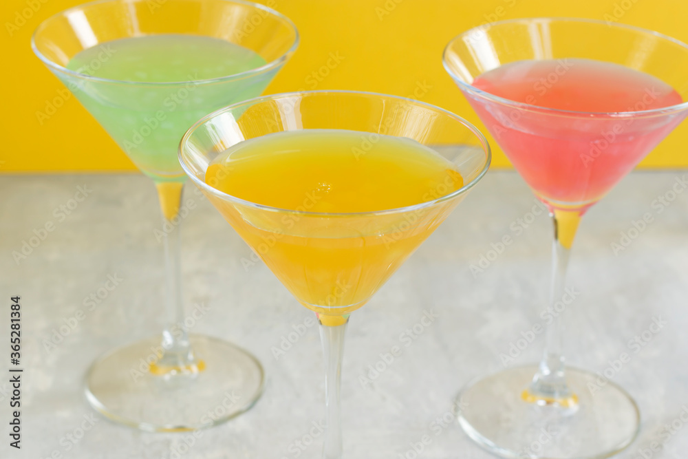 Several glasses of various delicious fruit non-alcoholic cocktails on a bright background. Health drinks