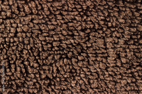 Close-up of brown wool carpet. Background, texture, pattern