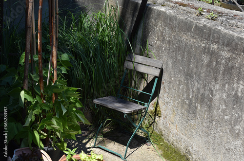 Ruhiger, schattiger Sitzplatz im Kleingarten, individuell gärtnern, Ruheoase zu Hause, Urlaub zu Hause genießen im kleinen Garten, phantasievoll gärtnern photo