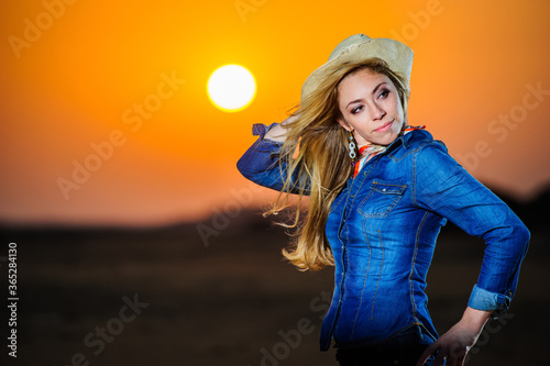 Portrait of beautiful country girl in front of red sunset.