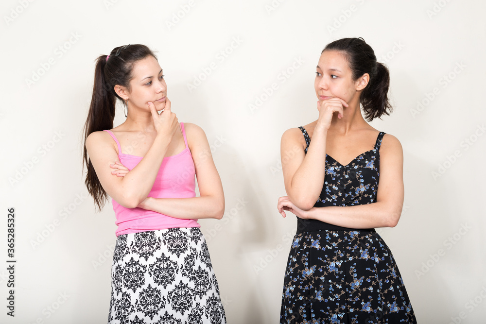 Portrait of two young beautiful women as sisters together Portrait of two young beautiful women as sisters together