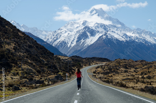 Girl running on the road to the Mount Cook, South Island, New Zealand, Mount Cook National Park