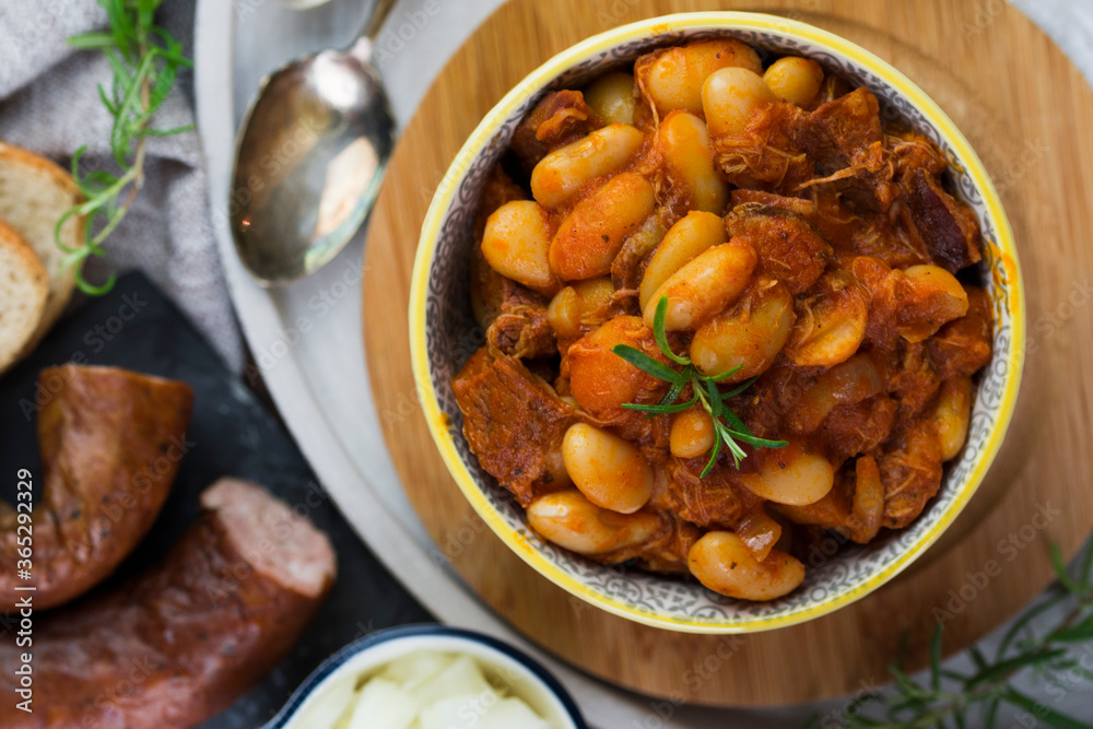 Stewed beans in tomato sauce with herbs and spices. Top view. Stewed beans in tomato sauce with herbs and spices. Top view.