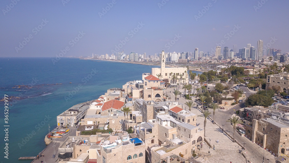 Tel Aviv and Jaffa skyline, aerial view above the old city and port of Jaffa and TLV coastline in the background.