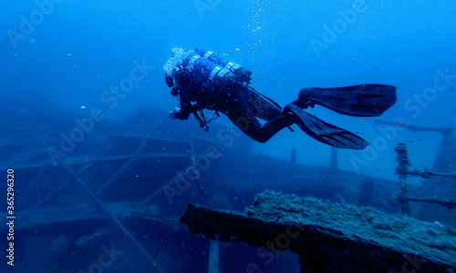 Scubadiving. Scuba divers diving at the shipwreck.