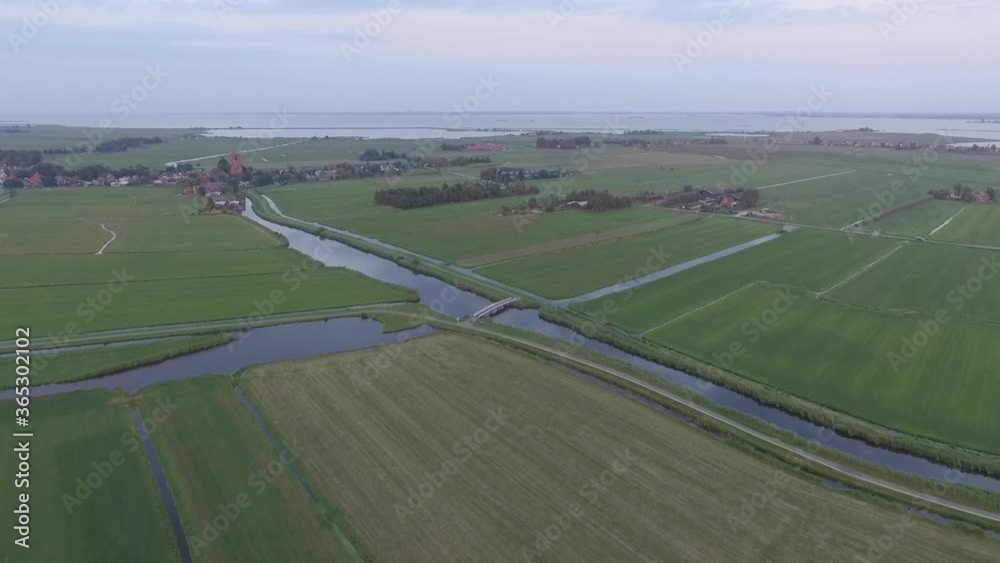 Droneshots of sheeps in the fields of Holland