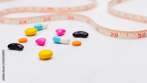 Measuring tape and pills for dieting concept. medical health care and prevention. Diet pills and measuring tape.