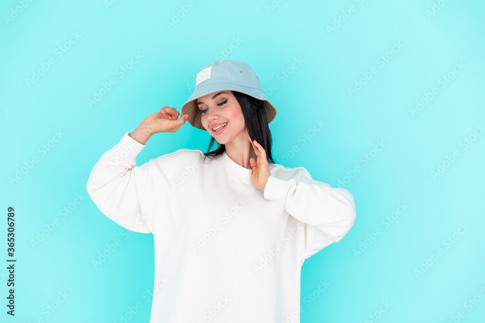 Fashion girl in blank sweatshirt jacket on a blue background Fashion girl in blank sweatshirt jacket on a blue background