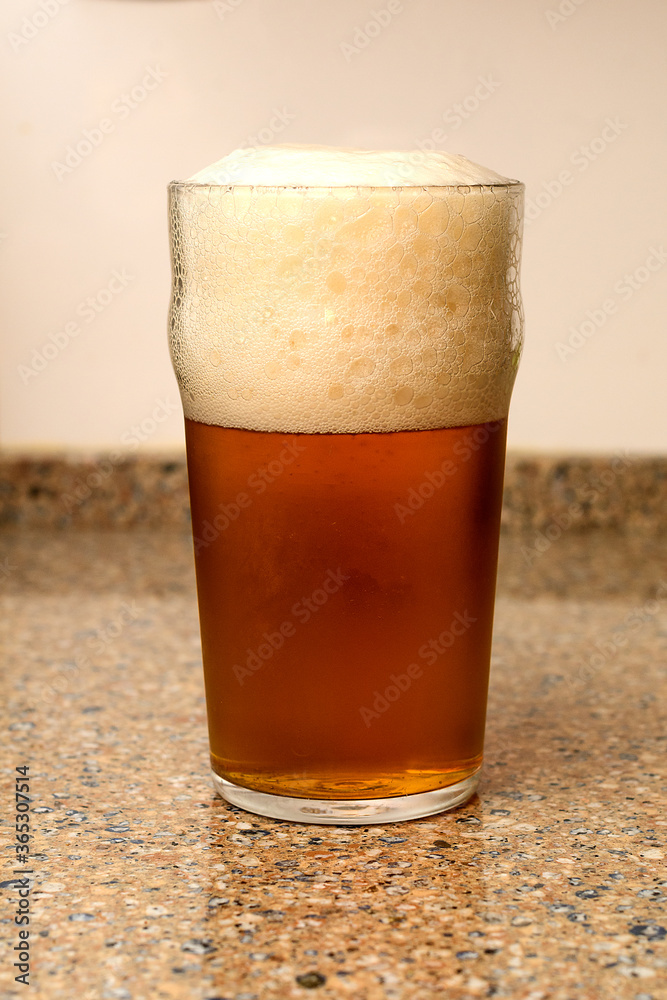 A very well poured beer in a glass A very well poured beer in a glass
