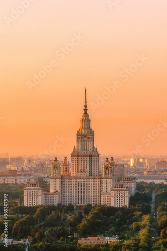 Moscow State University from a height. Panorama of the city at sunrise. Moscow landmark in the soft light of a golden dawn. A park. Stalin s skyscraper