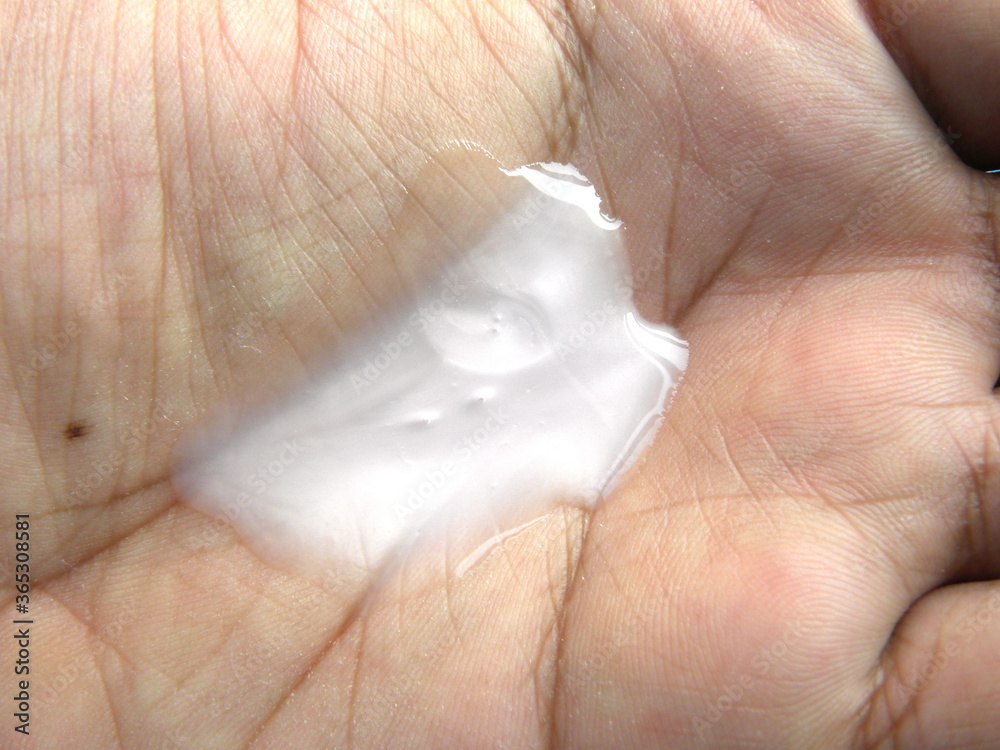 Dollop of white body wash liquid on palm of hand Dollop of white body wash liquid on palm of hand