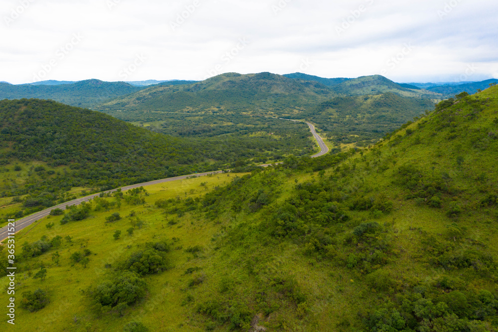 Panoramic aerial view of green meadows on mountain slope on a clear day, Panorama Route South Africa