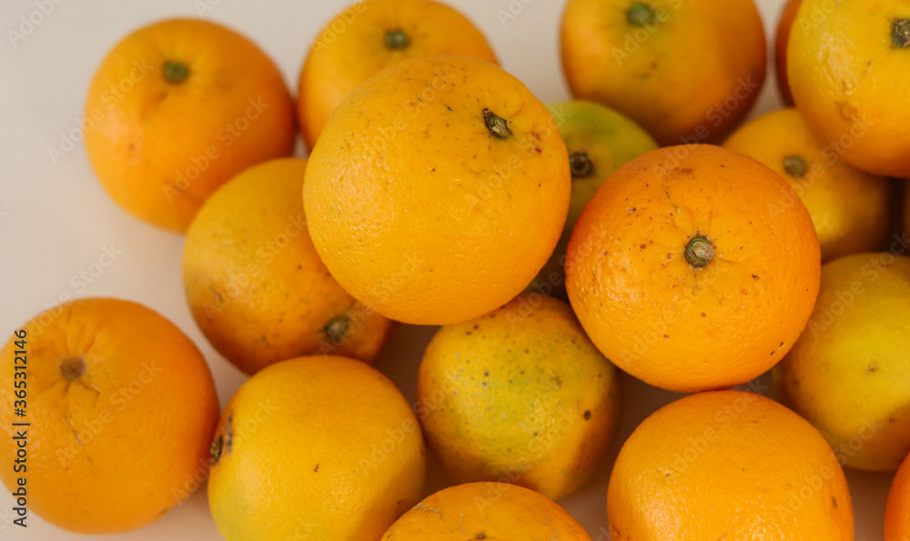 Beautiful oranges arranged on a table. A fruit rich in vitamin c. Beautiful oranges arranged on a table. A fruit rich in vitamin c.