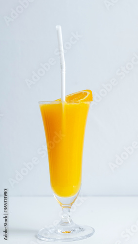 fresh orange juice in the glass with a tropical fruit slice ready for a drink