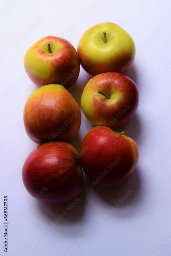 Six ripe red and green Braeburn apples on light background with copy space Six ripe red and green Braeburn apples on light background with copy space