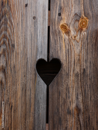 Heart shape cut in two wooden boards - close up of a wooden shutter, Kashubian Ethnographic Park, Wdzydze Kiszewskie, Poland