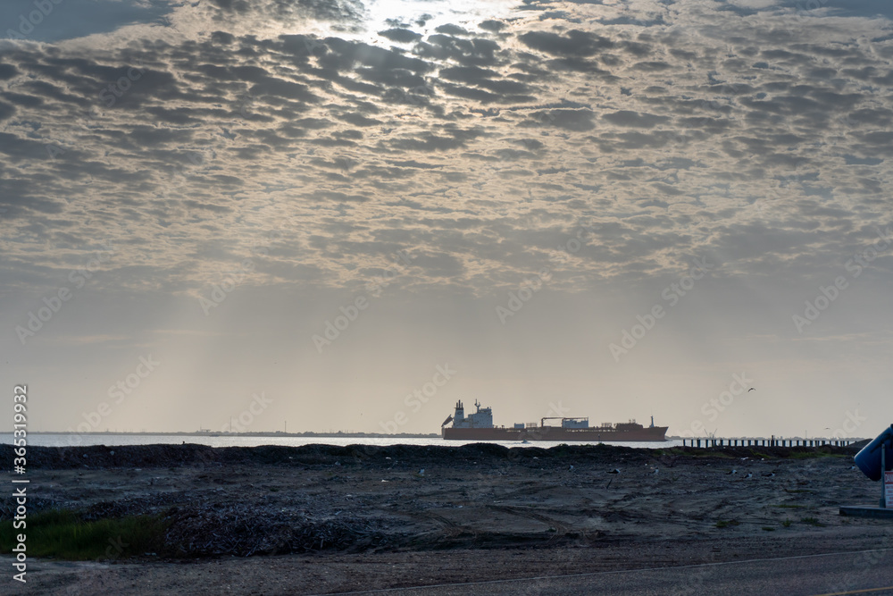 A cargo ship sailing through a Texas shipping channel. A cargo ship sailing through a Texas shipping channel.