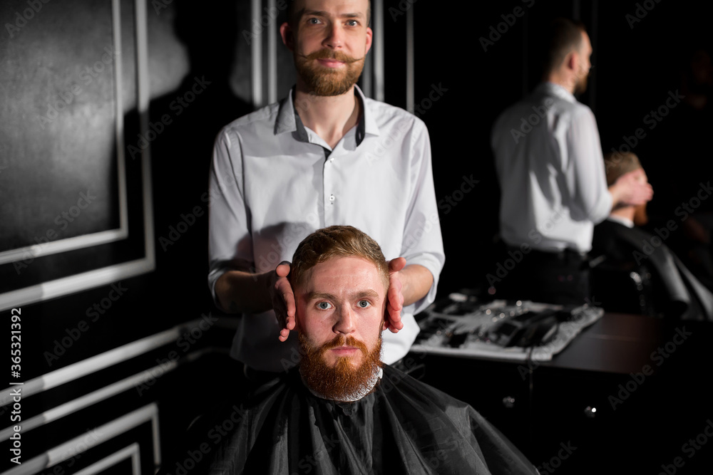Master cuts hair and beard in the Barber shop. Hairdresser makes hairstyle using scissors and a metal comb. Not satisfied with the work of the client. Master cuts hair and beard in the Barber shop. Hairdresser makes hairstyle using scissors and a metal comb. Not satisfied with the work of the client.
