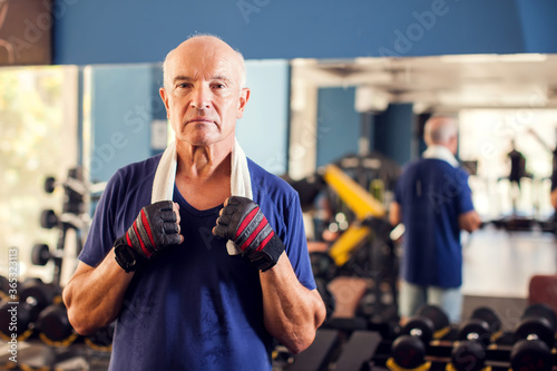 A portrait of senior man in the gym. People, health and lifestyle concept © Aleksej
