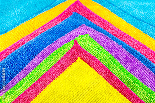 Background made of different colors of microfiber material superimposed on each other, in the shape of a triangle.