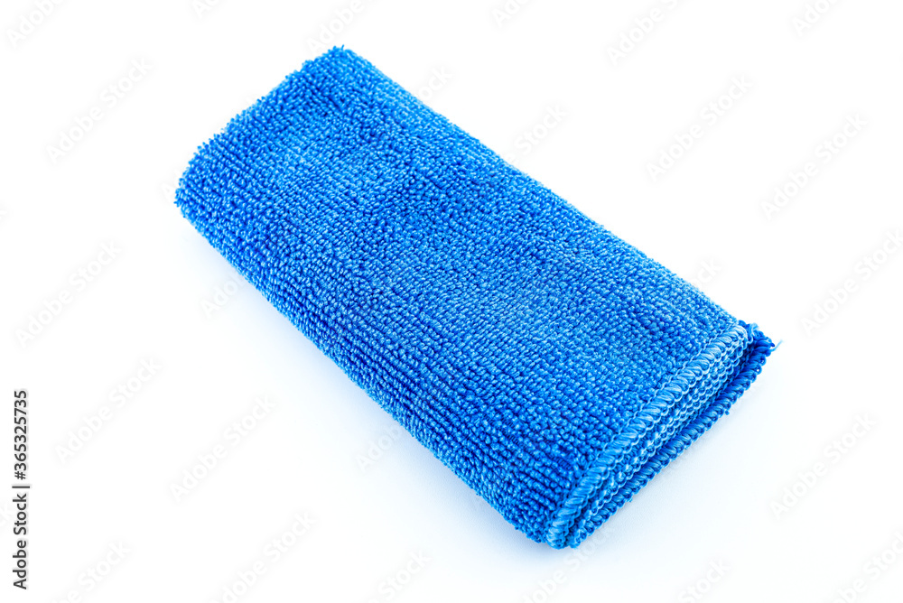 Blue microfiber fabric lying in the middle, isolated on a white background, top view. Blue microfiber fabric lying in the middle, isolated on a white background, top view.