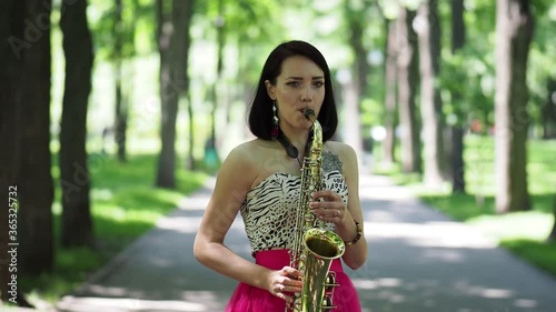 Girl playing at the saxophone photo