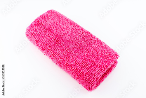 Pink microfiber fabric lying in the middle, isolated on a white background, top view.