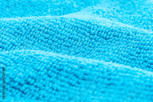 Background made of light blue microfiber fabric, selective focus.