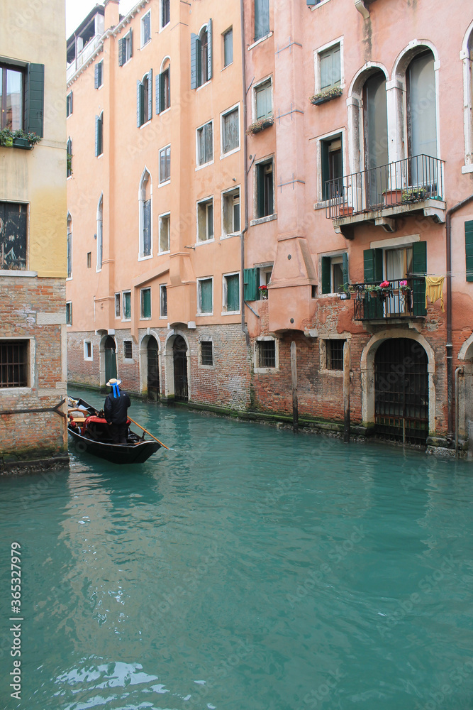 gondola in a turquoise canal in winter venice italy