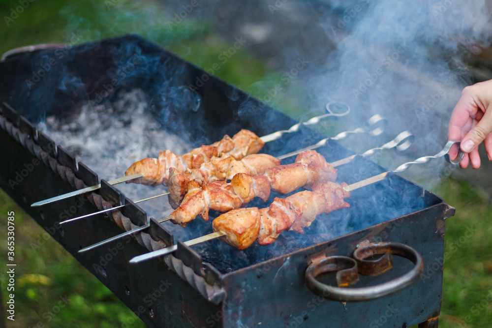 Pork skewers skewered on a skewer by hand and fried on the grill Pork skewers skewered on a skewer by hand and fried on the grill